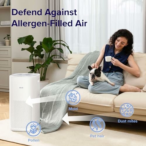 Woman with dog on couch next to air purifier.
