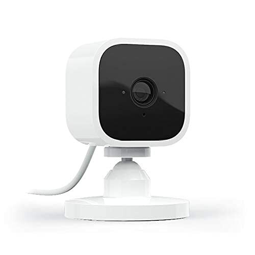 Compact white security camera with black lens on stand.