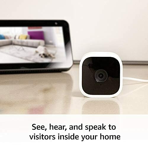 Smart home security camera with screen in background.