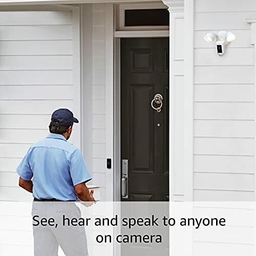 Person approaching a house with a smart doorbell camera