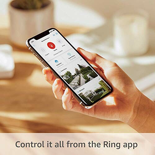Person holding a smartphone displaying the Ring app interface
